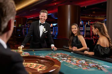 RK888 Casino Games — Enjoy nonstop entertainment A close-up shot of golden coins falling around a spinning roulette wheel, representing immersive casino action at RK888.