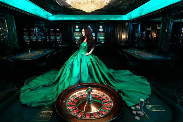 A woman in a luxurious green gown next to an ornate roulette wheel, capturing the upscale casino mood of RK888.